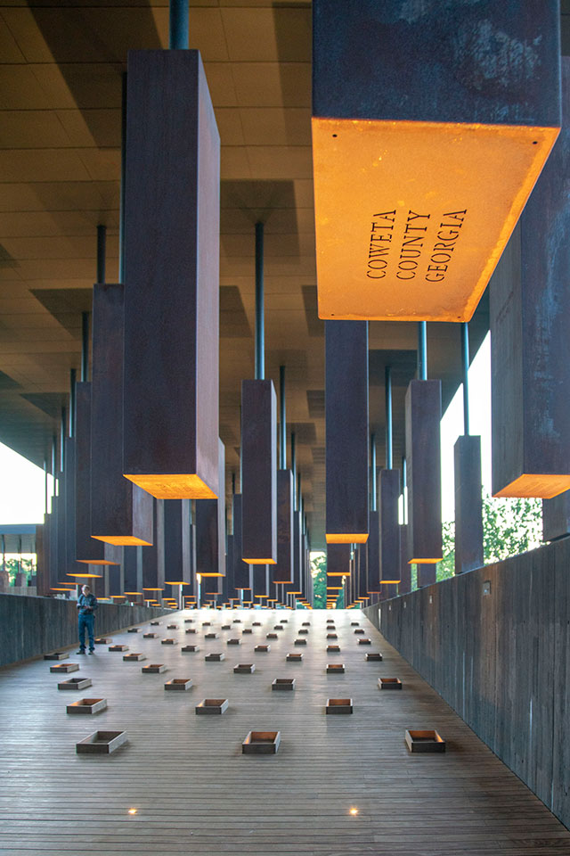 an interior view of the National Memorial for Peace and Justice featuring more than 800 corten steel monuments—one for each county where a racial terror lynching took place.