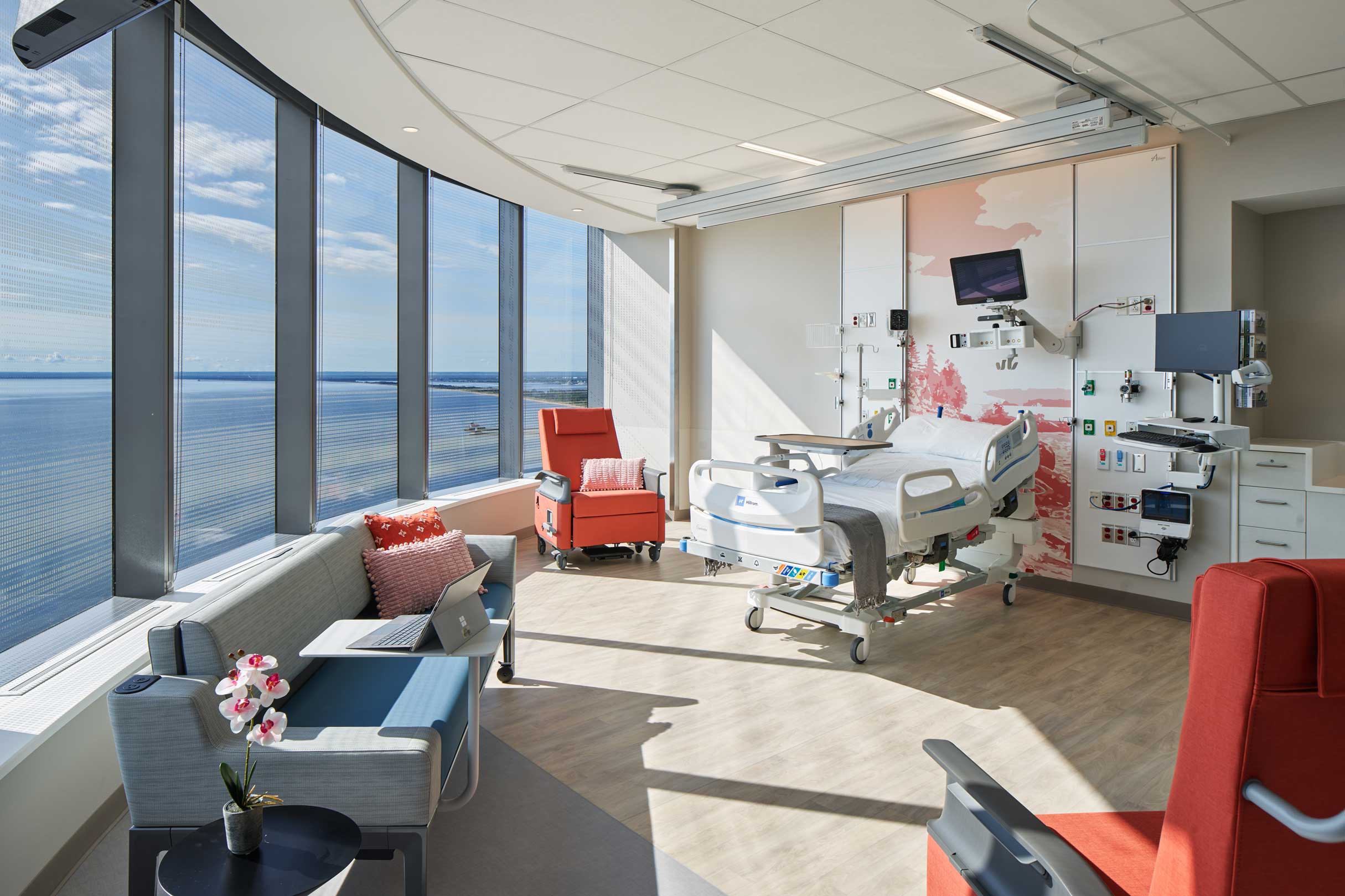a patient room with a water view from the window