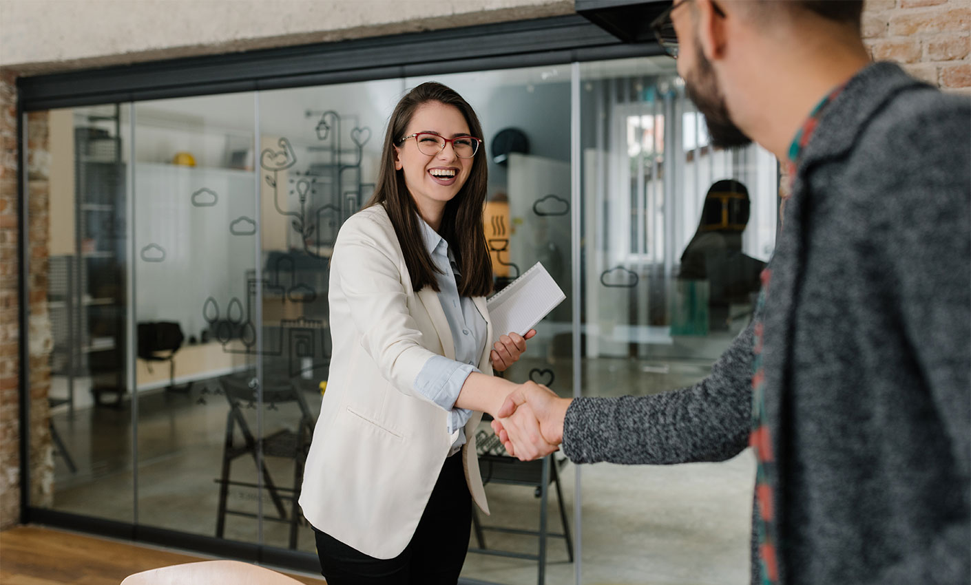 Woman shakes hands with an employee during a job interview